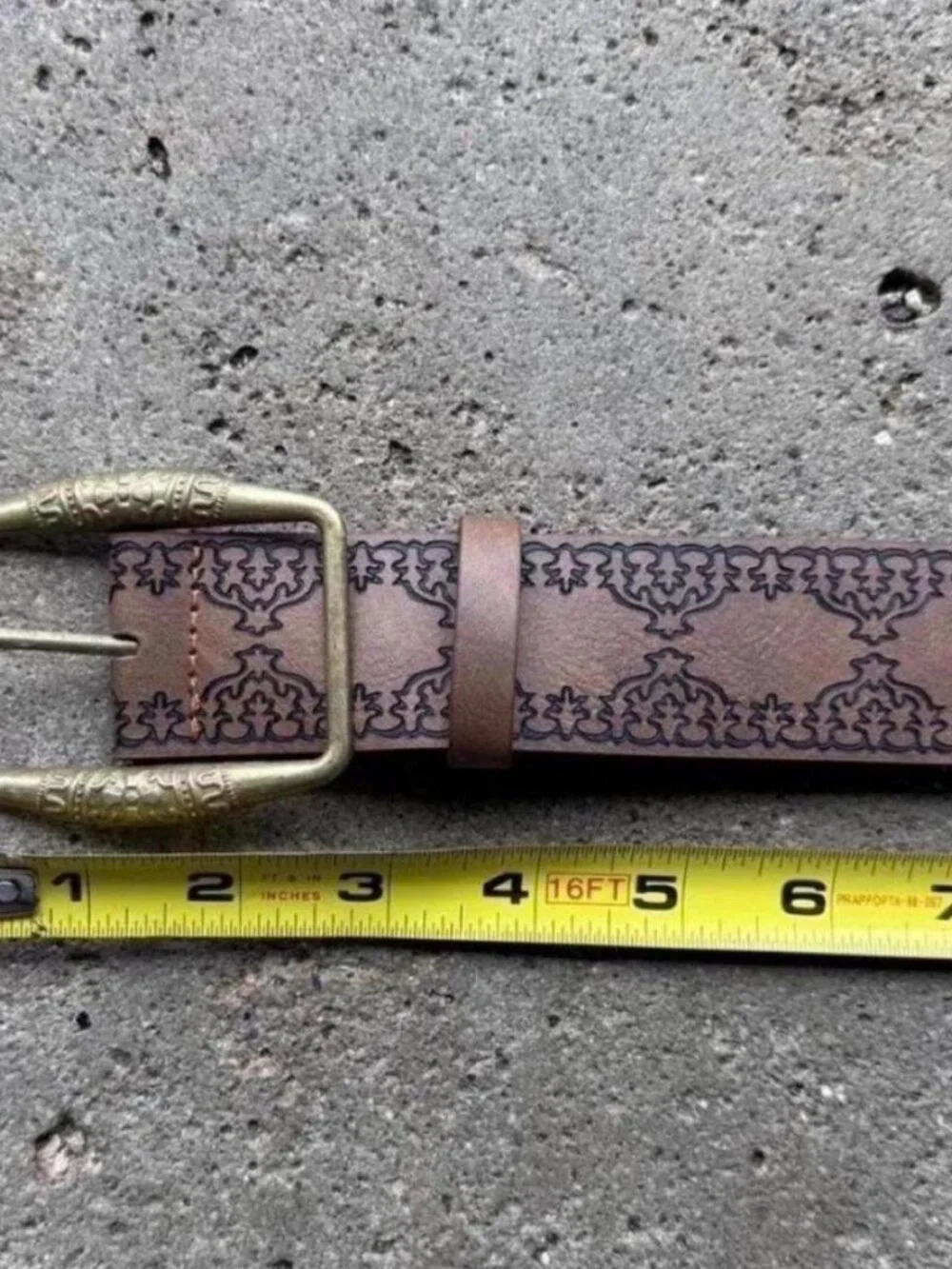 brown belt with embossed floral and scrollwork design
